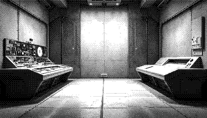 A symmetrical control room with two opposing consoles – one full of switches and labels, the other a smooth panel with a single reading slot, connected by a bundle of cables.